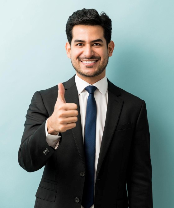 smiling-hispanic-male-executive-gesturing-thumbs-up-against-isolated-background
